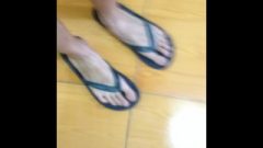 Thin Feet With Long Toes In Flip-flops