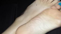 Wife Waving Her Nice Blue Pedicured Toes And Rubbing Feet Together