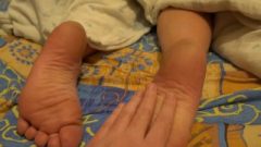 The Stepson Caresses The Feet Of His Mother While She Rests