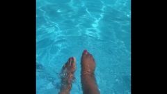 Ebony Splashes Her Feet In The Pool.