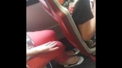 Flirtatious Woman Feet In White Flats On The Bus